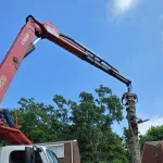 Tripoli Tree Care uses a large crane to lift a massive oak section over a Sewickley home.