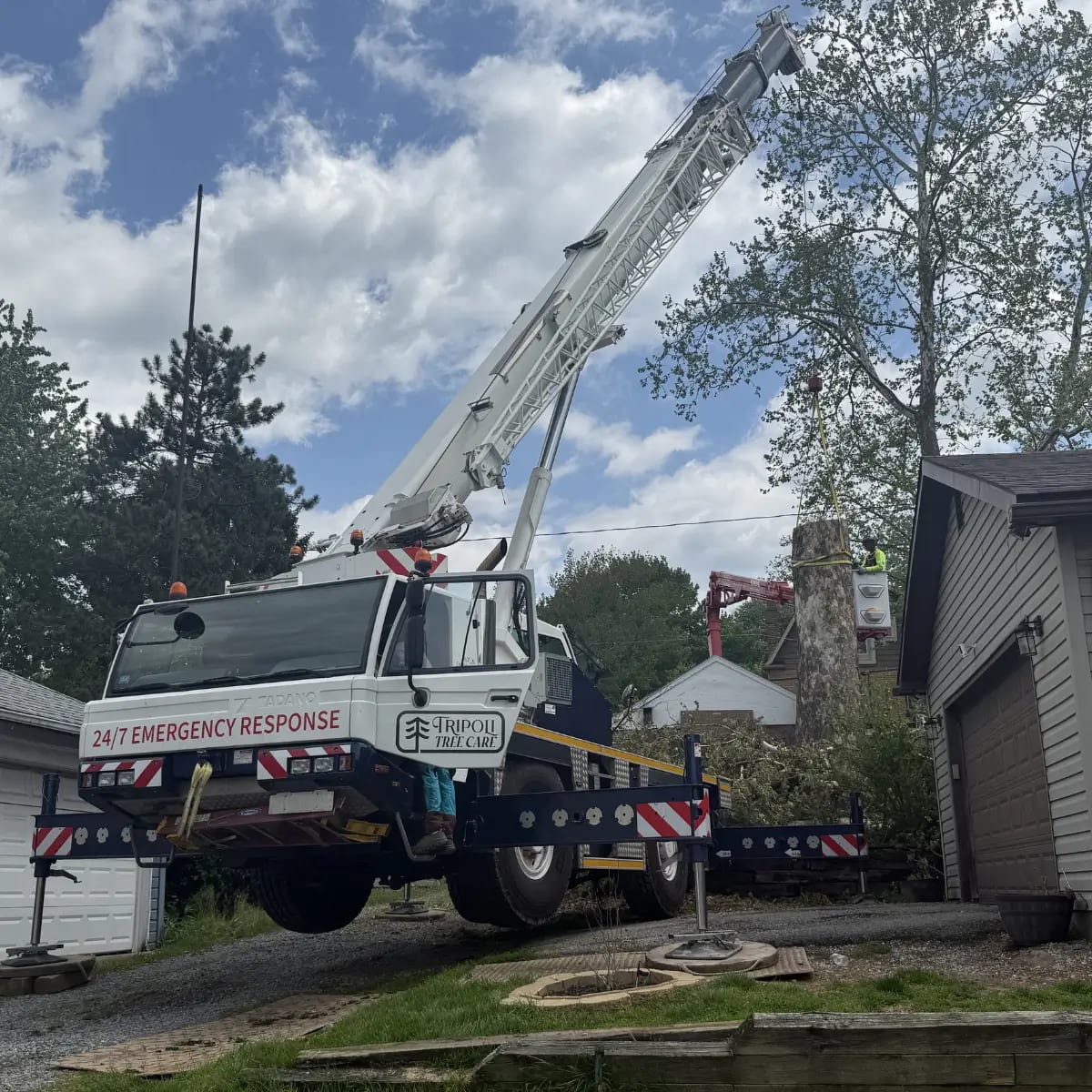 Tripoli Tree Care certified operator using a crane for controlled tree removal in Pittsburgh, PA