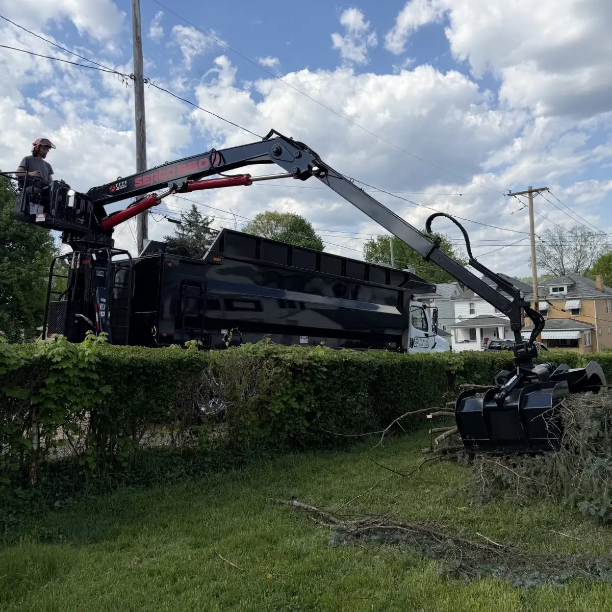 Tripoli Tree Care grapple truck handling fast, efficient debris cleanup on a Pittsburgh job site Large tree removal cleanup with grapple truck in Pittsburgh, PA